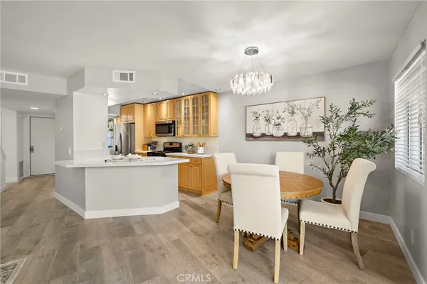 a kitchen with a dining table chairs and window