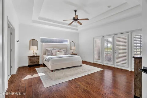 a spacious bedroom with a bed and a flat screen tv