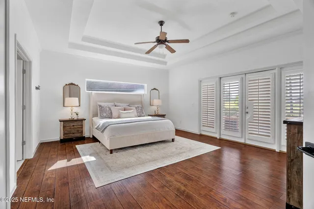 a spacious bedroom with a bed and a flat screen tv