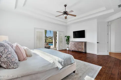 a bedroom with furniture and a flat screen tv