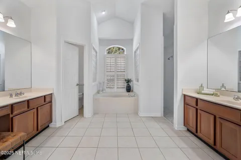 a spacious bathroom with a sink and a mirror