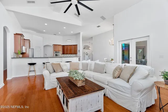 a spacious bedroom with a bed and a chandelier