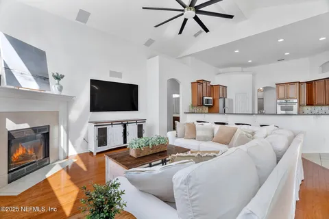 a spacious bedroom with a bed and a flat screen tv