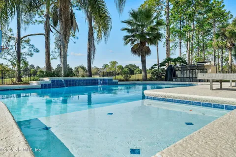 an aerial view of residential houses with outdoor space and ocean view
