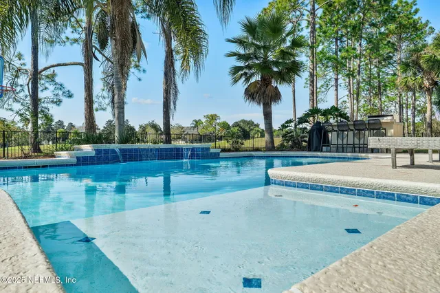 an aerial view of residential houses with outdoor space and ocean view