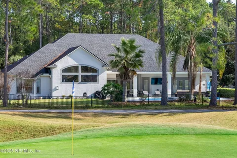 an aerial view of a house with a yard basket ball court