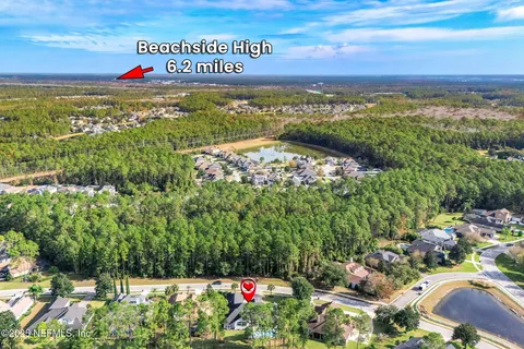 a living room with furniture and a dining table with wooden floor