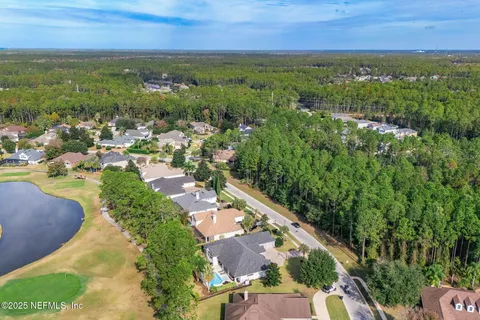 a view of a swimming pool with a patio and a garden