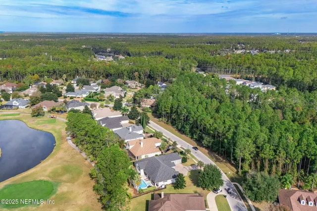 a view of a swimming pool with a patio and a garden