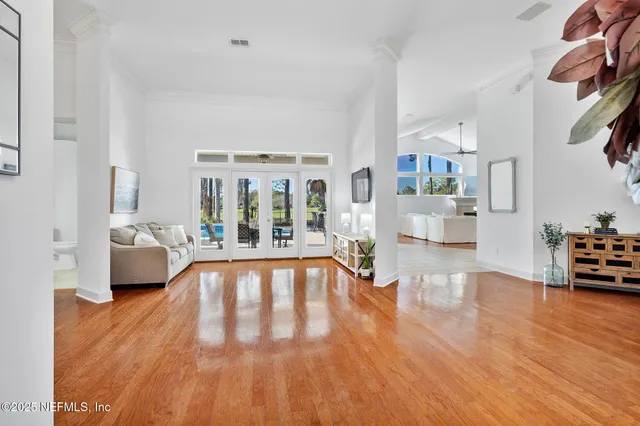 a living room with furniture and wooden floor