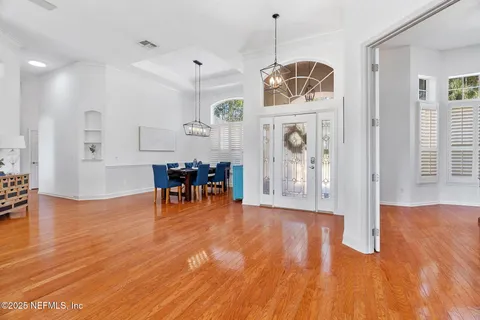 a view of a dining room with furniture wooden floor and chandelier