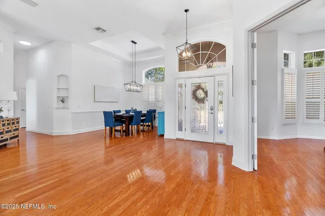 a view of a dining room with furniture wooden floor and chandelier