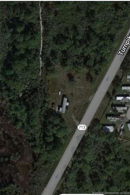6415 Turnpike Feeder Road Fort Pierce, FL 34951 - Photo 8 of 8 a view of a house with a yard