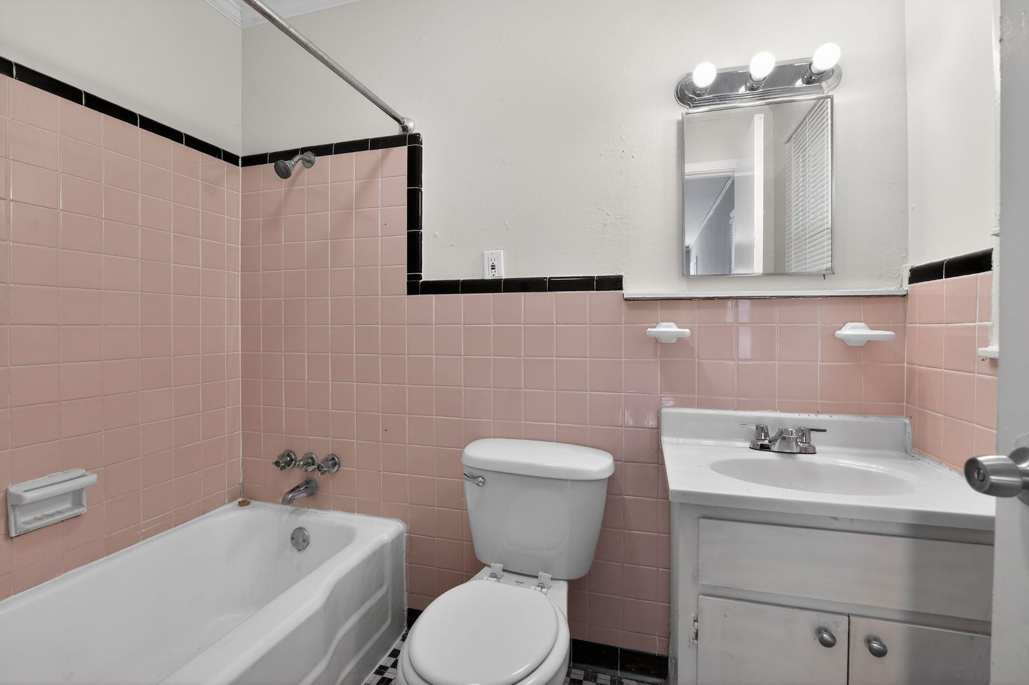 4094 Auburn Road Memphis, TN 38116 - Photo 20 of 30 Full bathroom with tile walls, vanity, shower / bath combination, and a wainscoted wall