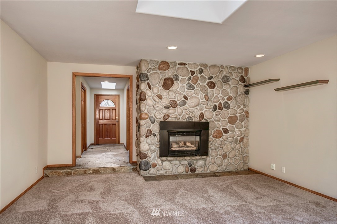 14437 157th Place Southeast Renton, WA 98059 - Photo 2 of 18 an empty room with a fireplace and window