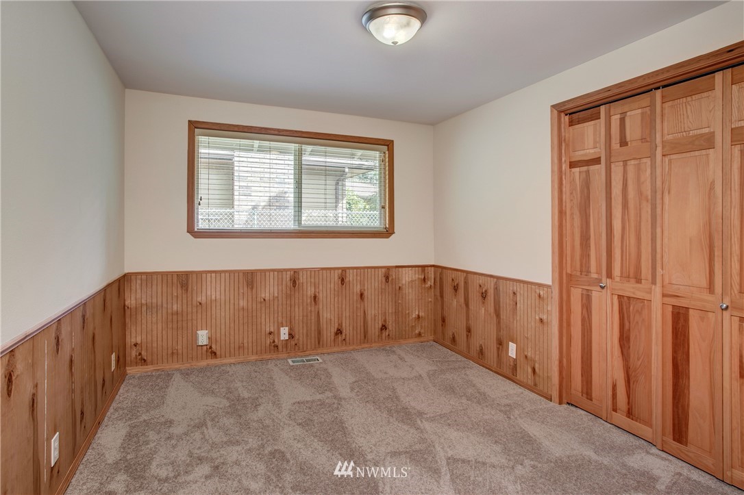 14437 157th Place Southeast Renton, WA 98059 - Photo 11 of 18 an empty room with wooden floor and windows