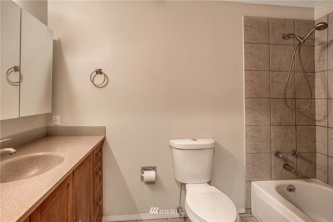 14437 157th Place Southeast Renton, WA 98059 - Photo 16 of 18 a bathroom with a sink toilet vanity and tub