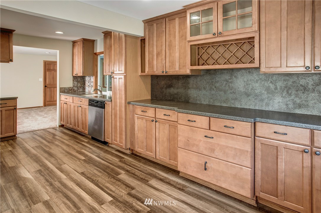 14437 157th Place Southeast Renton, WA 98059 - Photo 8 of 18 a kitchen with granite countertop cabinets stainless steel appliances and a counter space