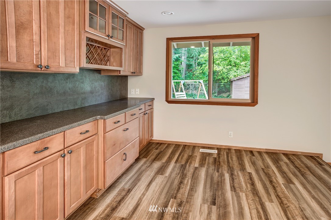 14437 157th Place Southeast Renton, WA 98059 - Photo 9 of 18 a kitchen with granite countertop white cabinets and window
