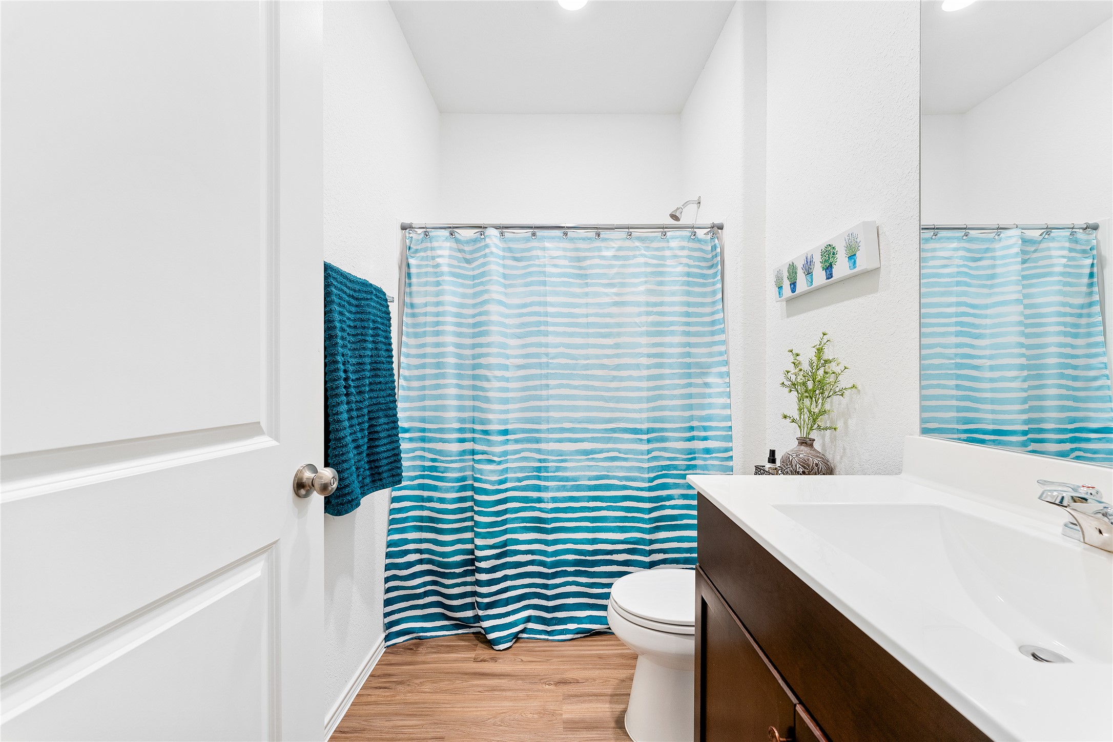 6009 Jagger Avenue Austin, TX 78747 - Photo 19 of 24 a bathroom with a sink a toilet and shower