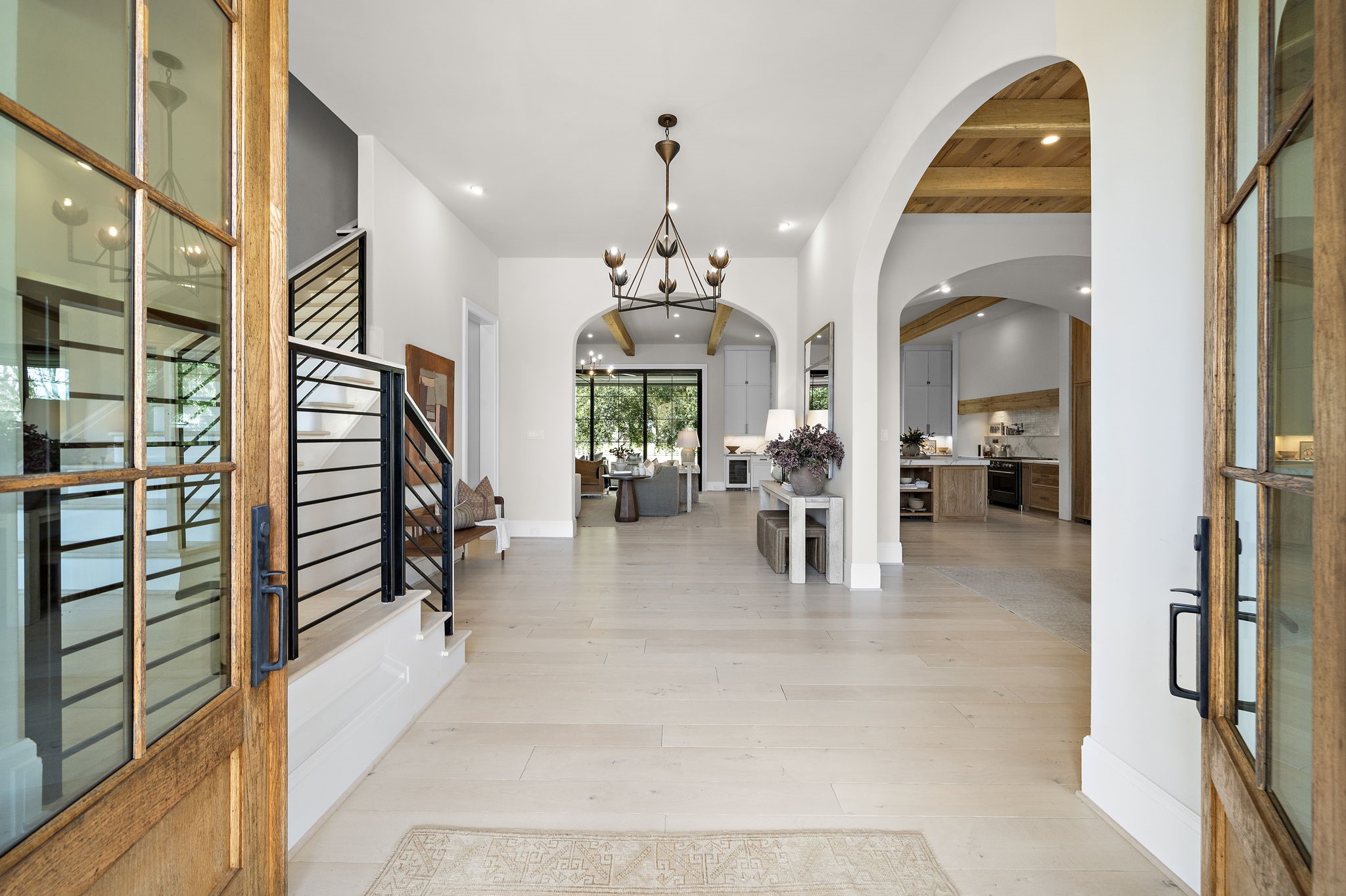 5511 Fulbrook Road Fulshear, TX 77441 - Photo 13 of 50 This gorgeous entryway features Certified French White Oak flooring, high ceilings, and elegant chandelier. Arched doorways lead to an open living area and a formal dining room with a wood accented ceiling.