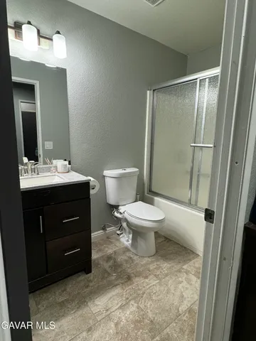 a bathroom with a toilet sink and a mirror