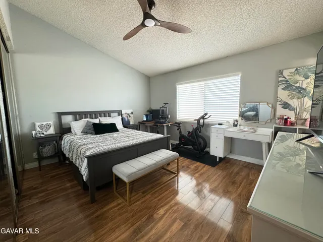 a bedroom with a bed a table and chair