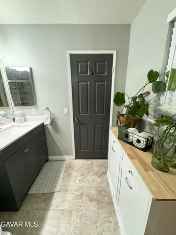 a spacious bathroom with a sink and a mirror