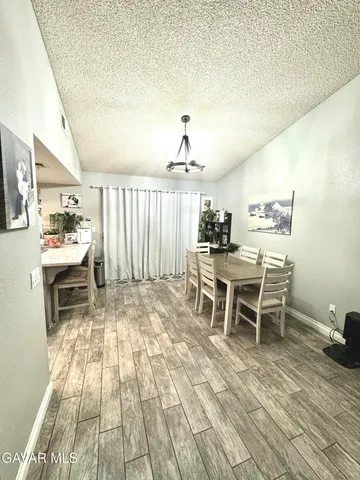 a dining room with furniture and wooden floor