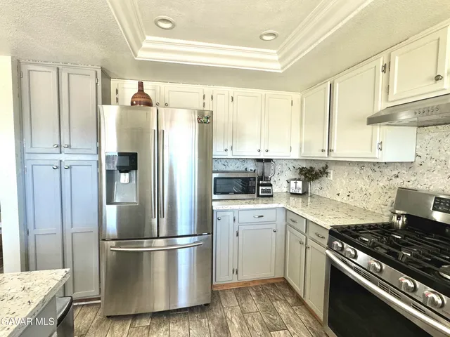 a kitchen with a refrigerator a sink and a stove