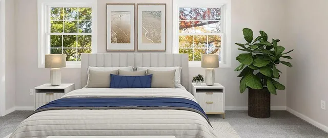 a bedroom with a bed and a potted plant