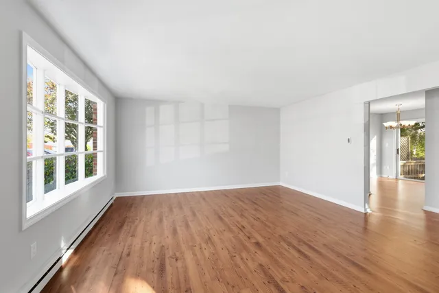 wooden floor in an empty room with a window
