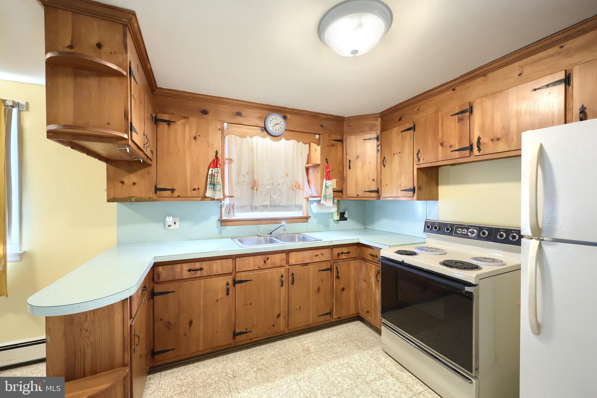 1365 Burkholder Road Red Lion, PA 17356 - Photo 20 of 34 a kitchen with stainless steel appliances granite countertop a sink a stove and a refrigerator