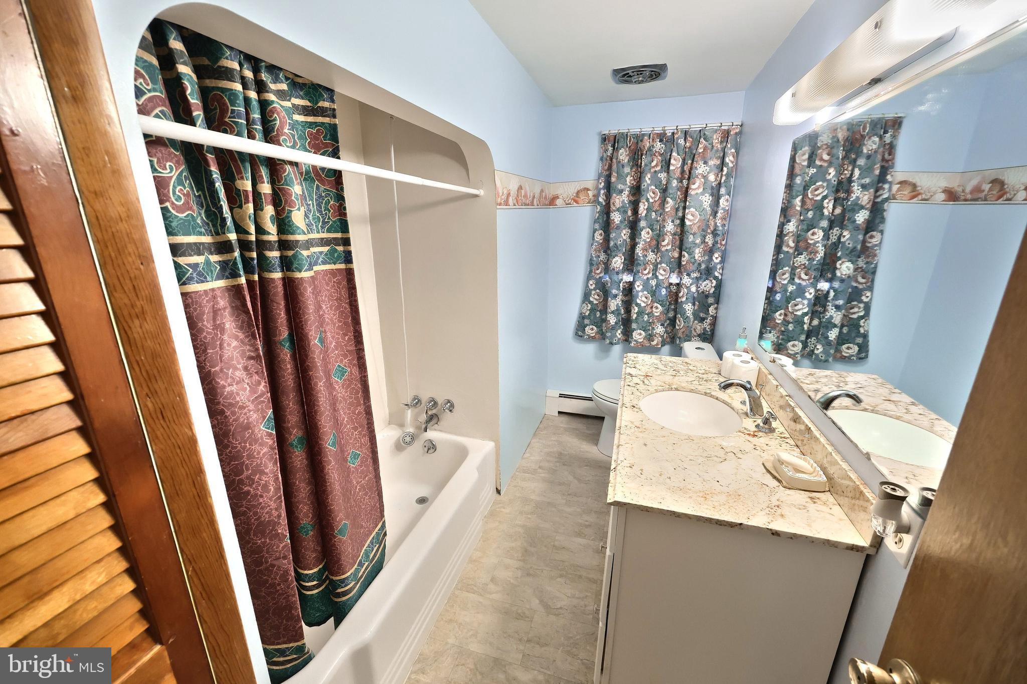 1365 Burkholder Road Red Lion, PA 17356 - Photo 24 of 34 a bathroom with a sink a mirror and shower