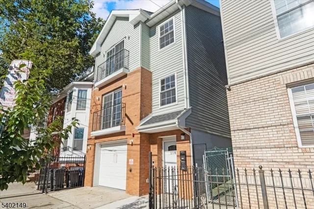 a view of a brick house with many windows