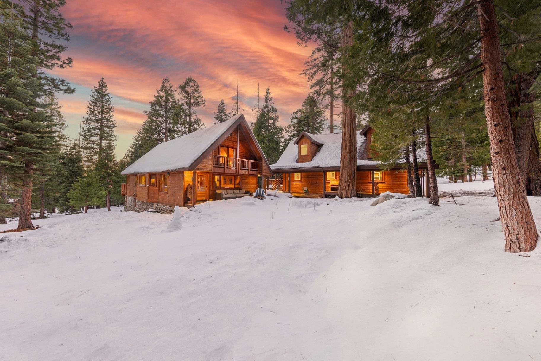 a view of a house with a yard covered in snow