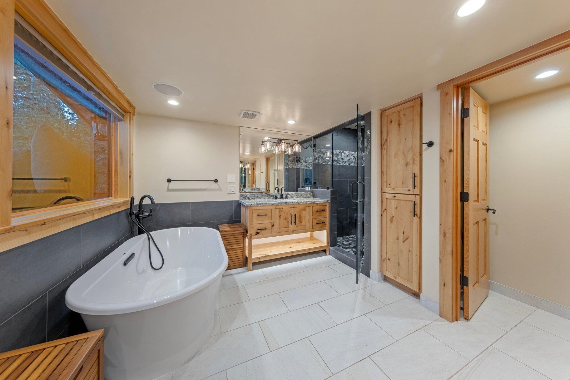 6442 Donner Road Tahoe Vista, CA 96148 - Photo 11 of 28 a bathroom with a tub shower and sink