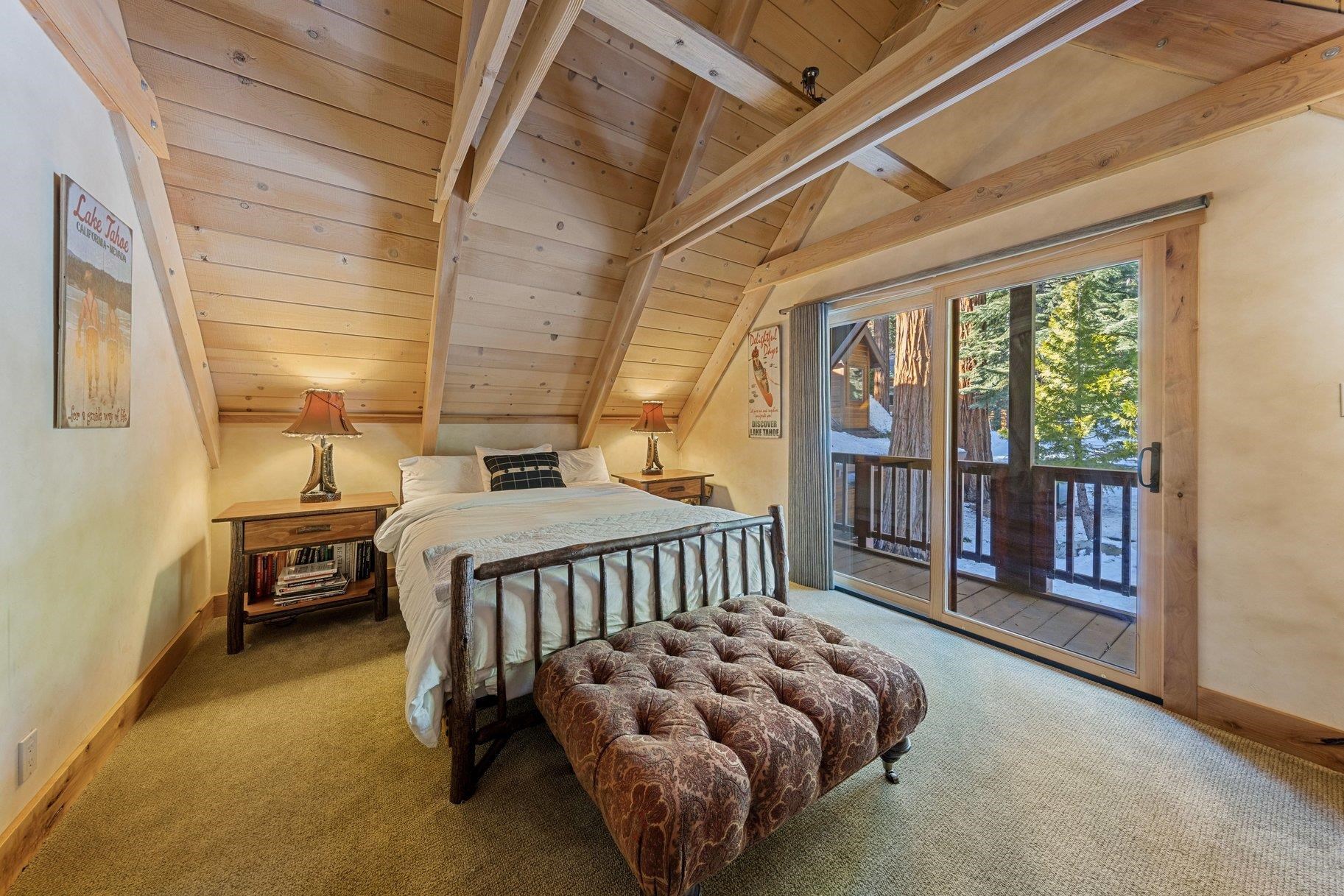 6442 Donner Road Tahoe Vista, CA 96148 - Photo 12 of 28 a bedroom with bed and wooden floor
