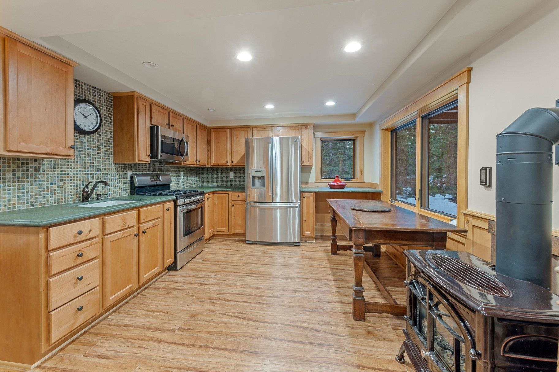 6442 Donner Road Tahoe Vista, CA 96148 - Photo 16 of 28 a kitchen with stainless steel appliances granite countertop a refrigerator and a stove top oven
