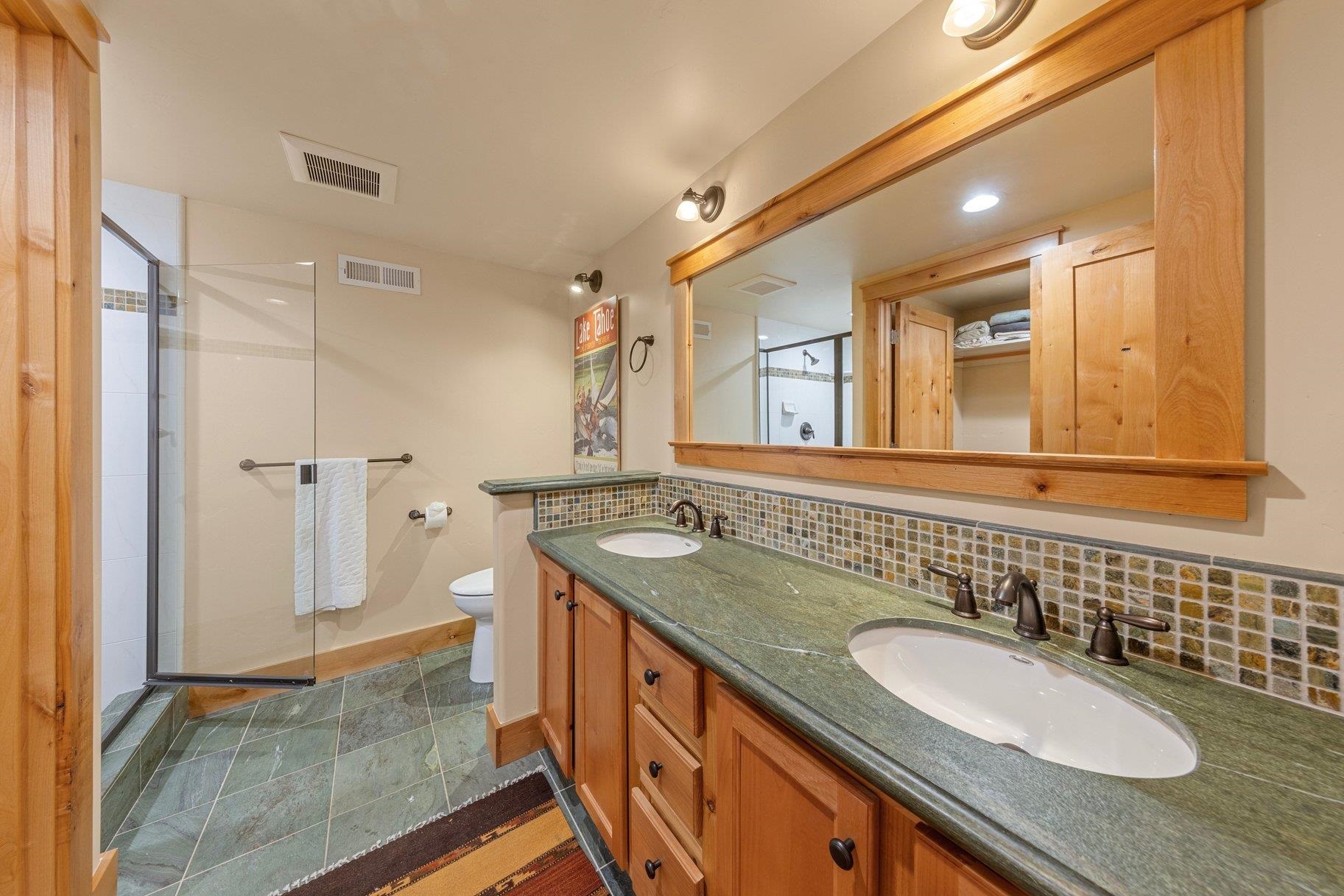 6442 Donner Road Tahoe Vista, CA 96148 - Photo 18 of 28 a bathroom with a granite countertop sink and a mirror