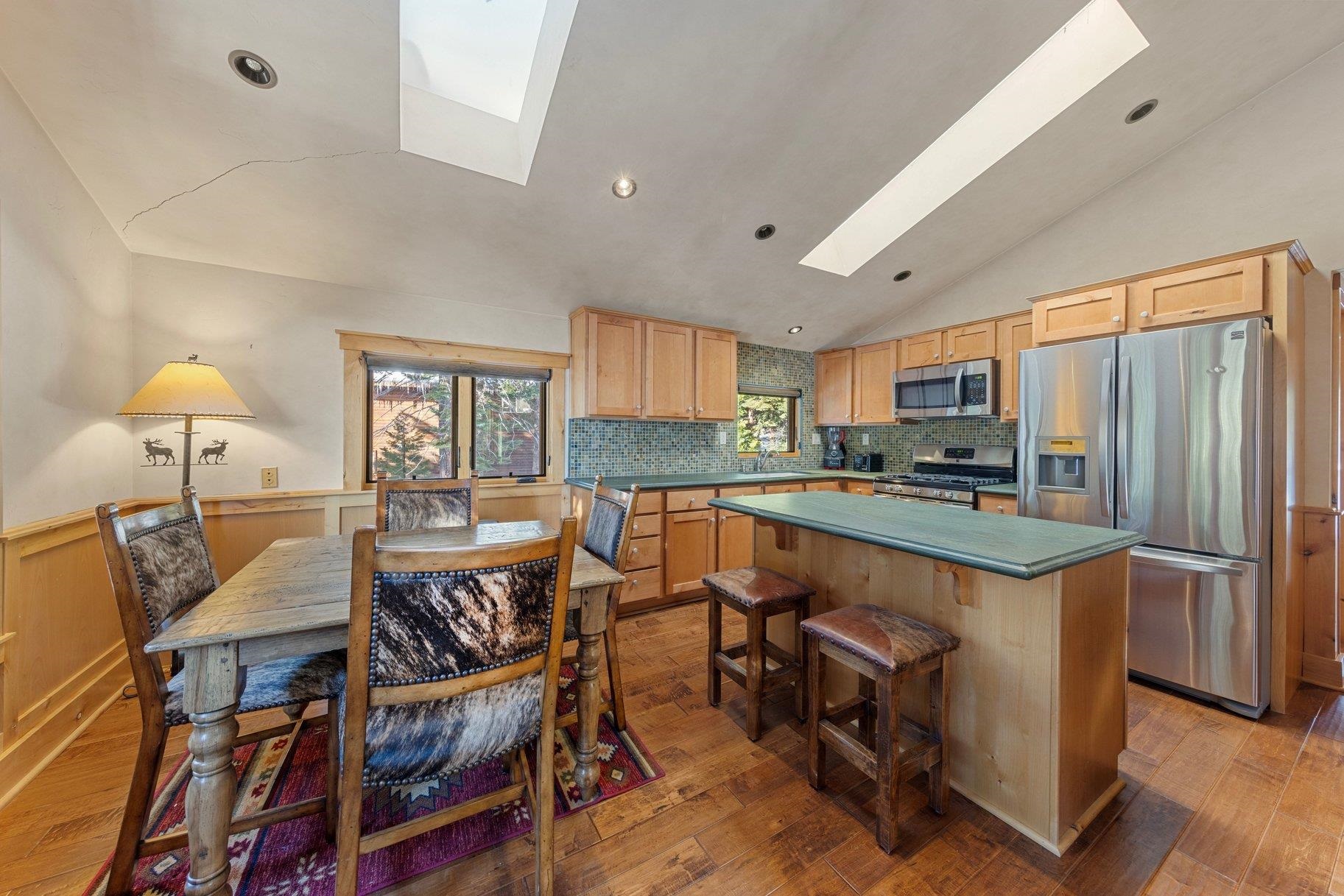 6442 Donner Road Tahoe Vista, CA 96148 - Photo 24 of 28 a kitchen with stainless steel appliances granite countertop a stove top oven a sink dishwasher and a refrigerator