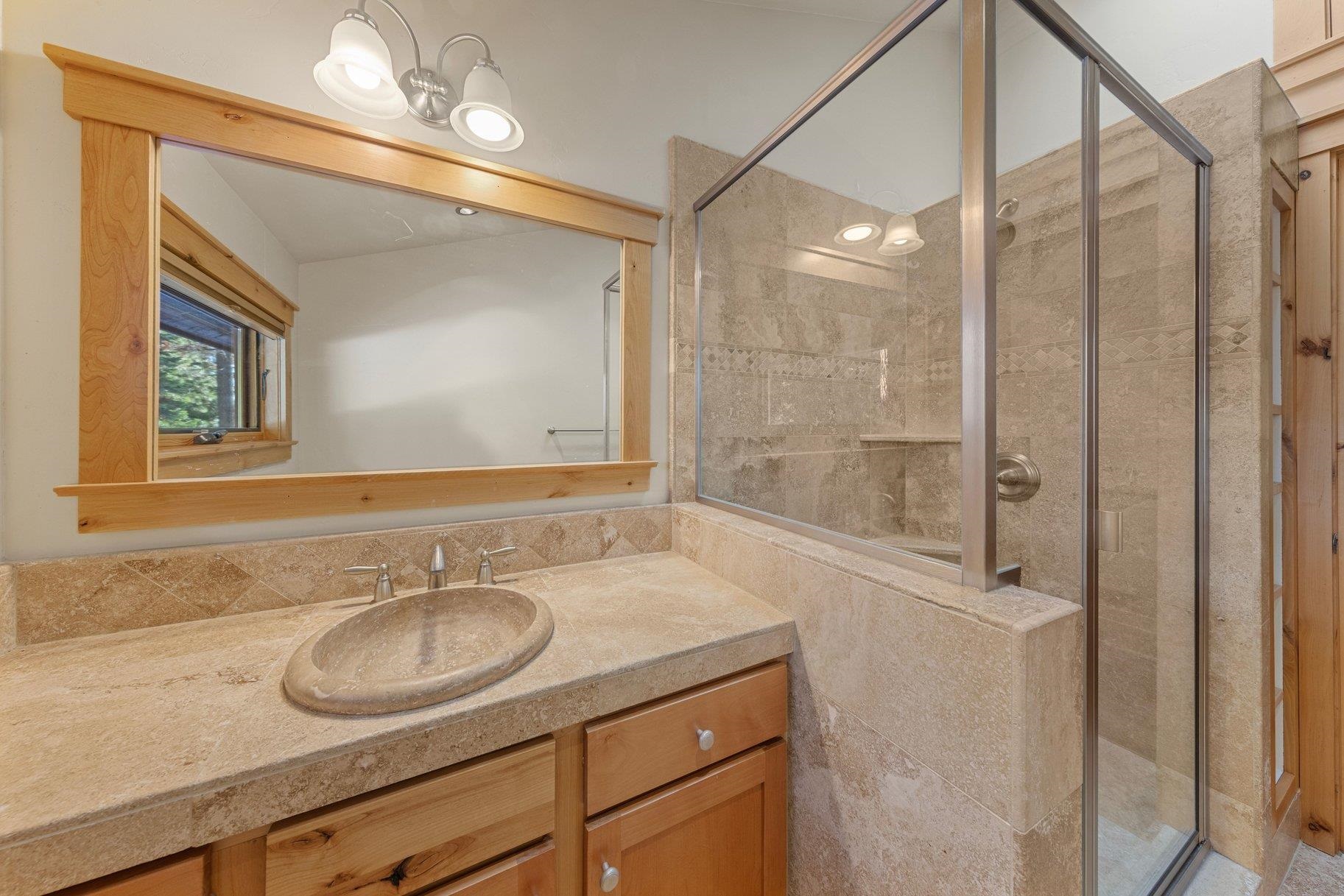 6442 Donner Road Tahoe Vista, CA 96148 - Photo 26 of 28 a bathroom with a sink double vanity and a mirror
