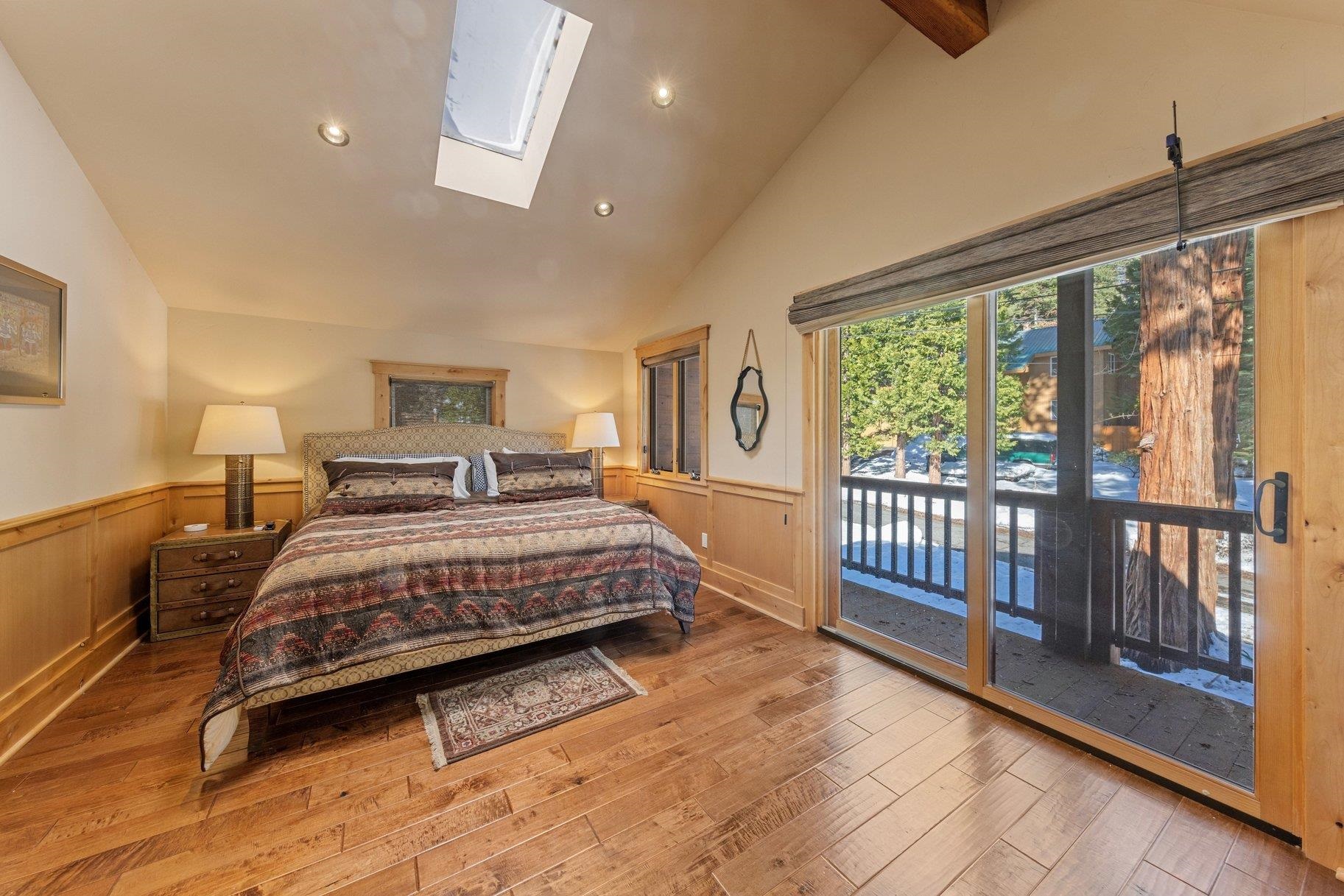 6442 Donner Road Tahoe Vista, CA 96148 - Photo 27 of 28 a bedroom with a bed and a large window