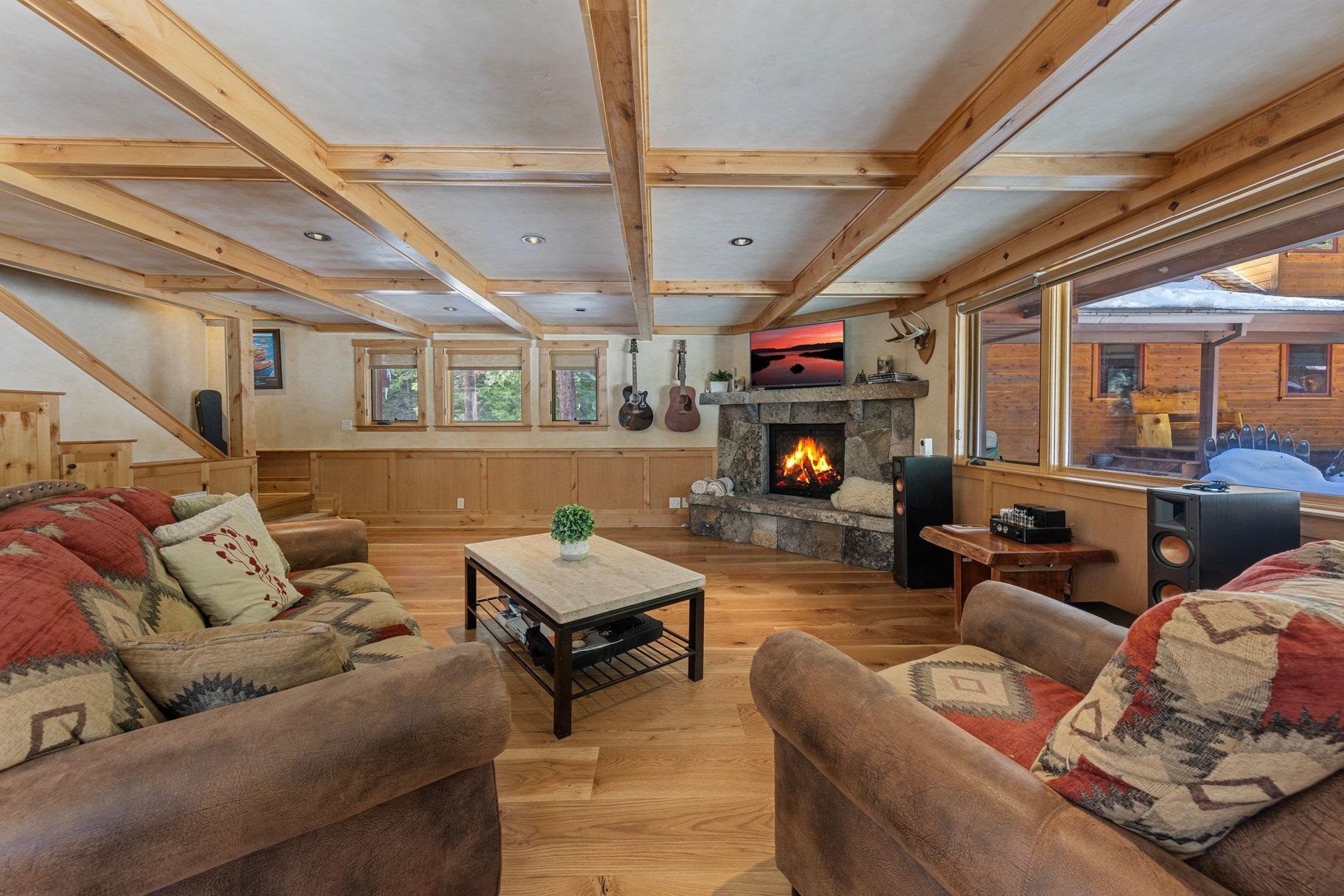 6442 Donner Road Tahoe Vista, CA 96148 - Photo 5 of 28 a living room with furniture a fireplace and a flat screen tv