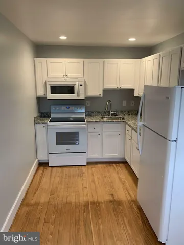 a kitchen with stainless steel appliances a stove a sink and a refrigerator
