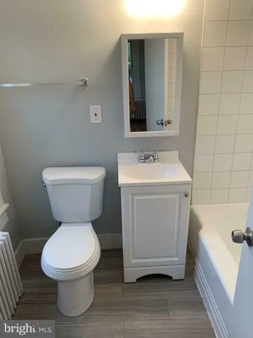 a white toilet sitting next to a bathroom sink
