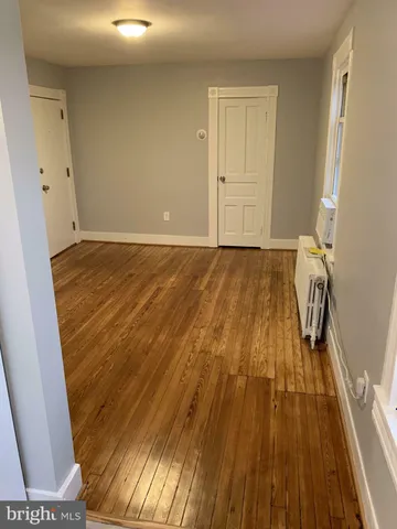 a view of a room with wooden floor