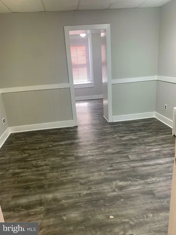 a view of room with window and wooden floor
