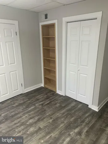 a view of wooden floor and closet in a room