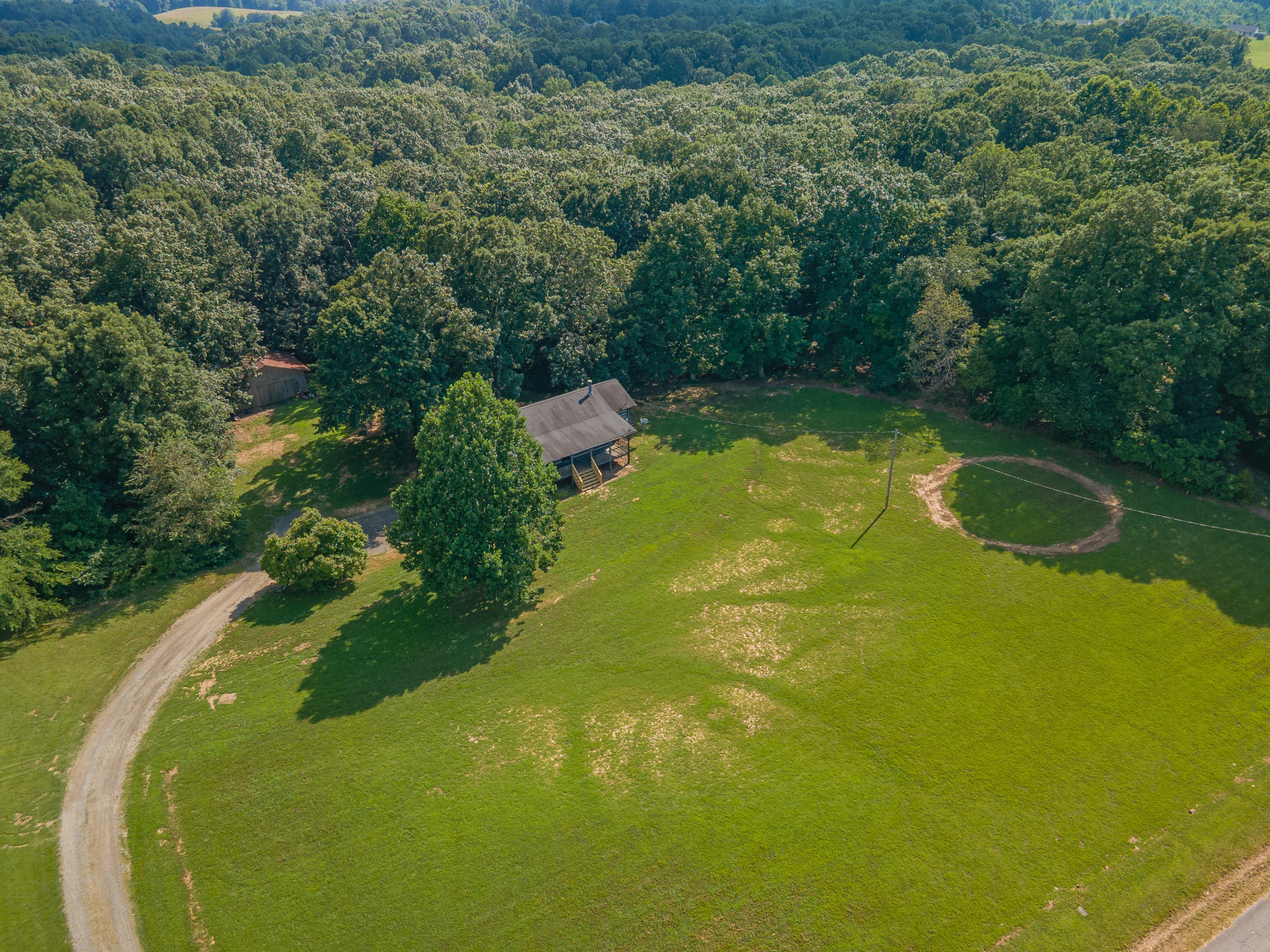 2151 Maysville Road Dickson, TN 37055 - Photo 13 of 98 a view of a swimming pool with a yard and large trees